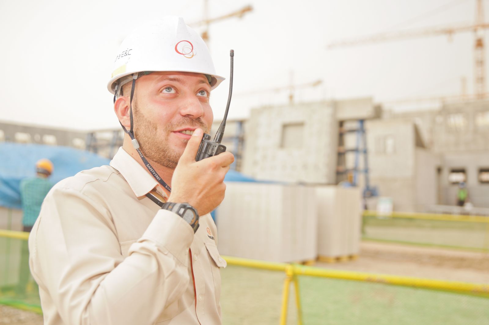 Professional builder in safety equipment coordinating on a construction site